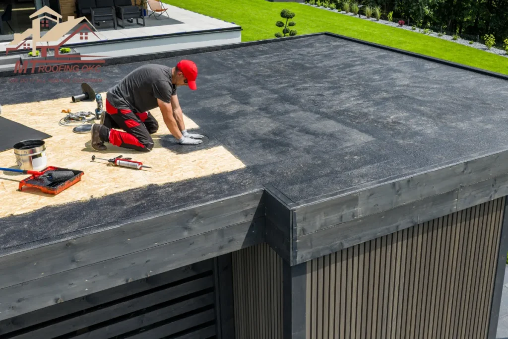 Roofer Applying Waterproof Membrane on Flat Roof